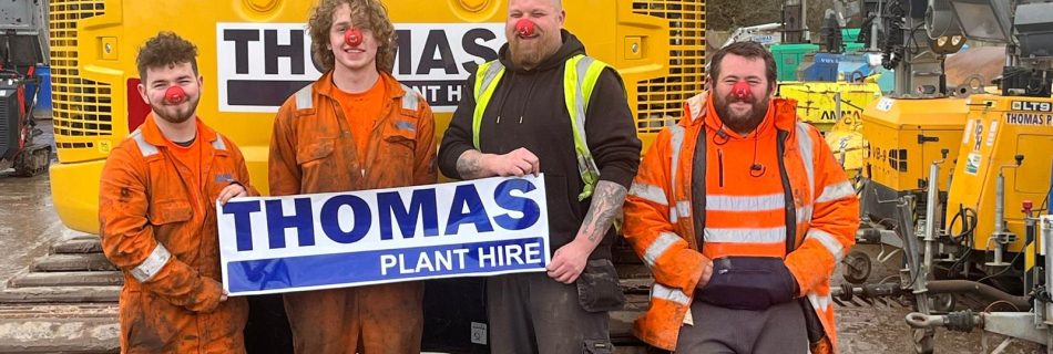Thomas staff in front of digger with red noses on